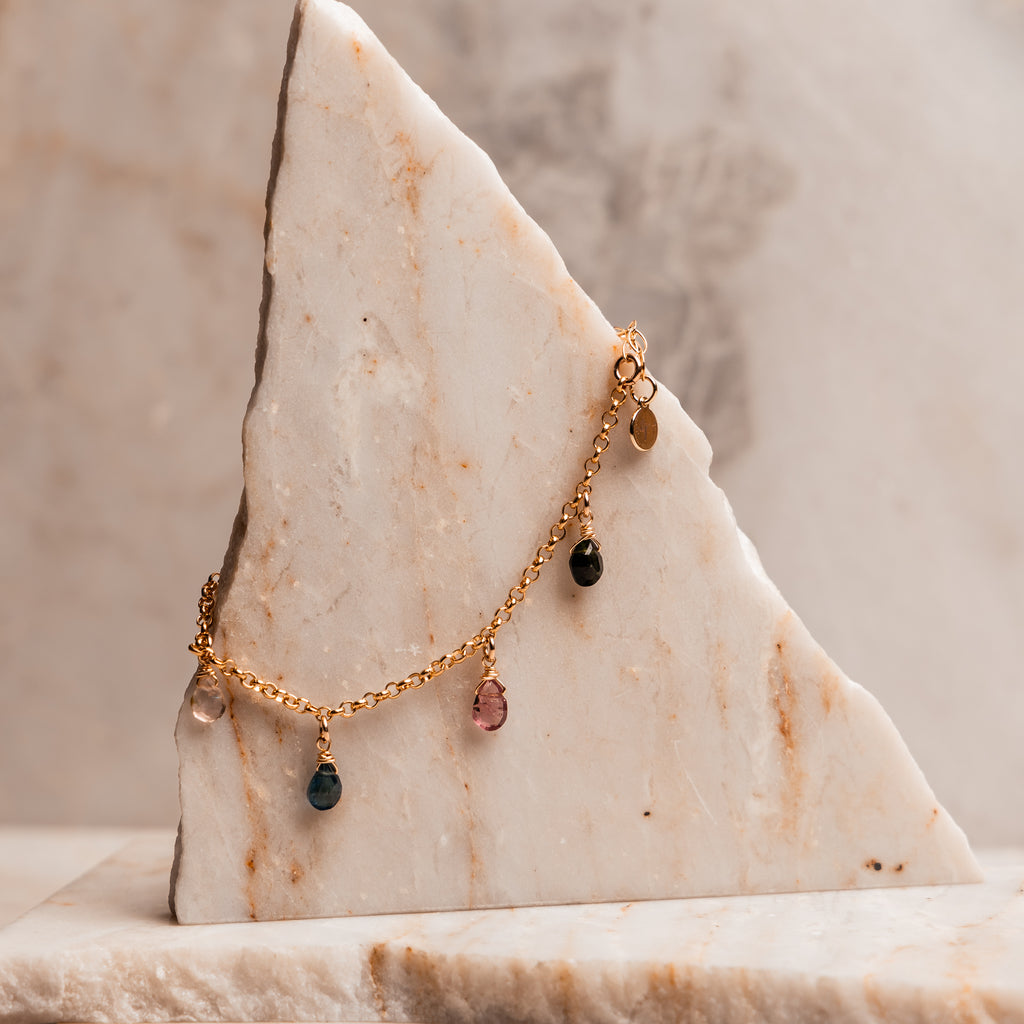 Adjustable 7-8 inch gold bracelet with faceted teardrop tourmaline stones