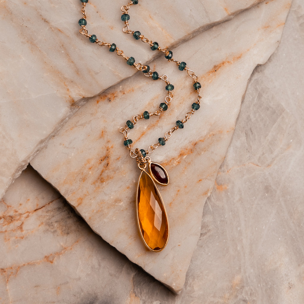 Handcrafted gold-filled necklace featuring blue topaz chain and amber teardrop pendant