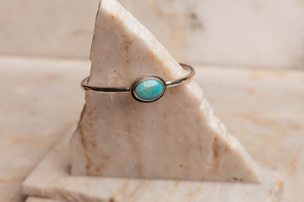 "Minimalist Designer Anika Silver Bracelet with natural turquoise stone, stackable cuff design."

