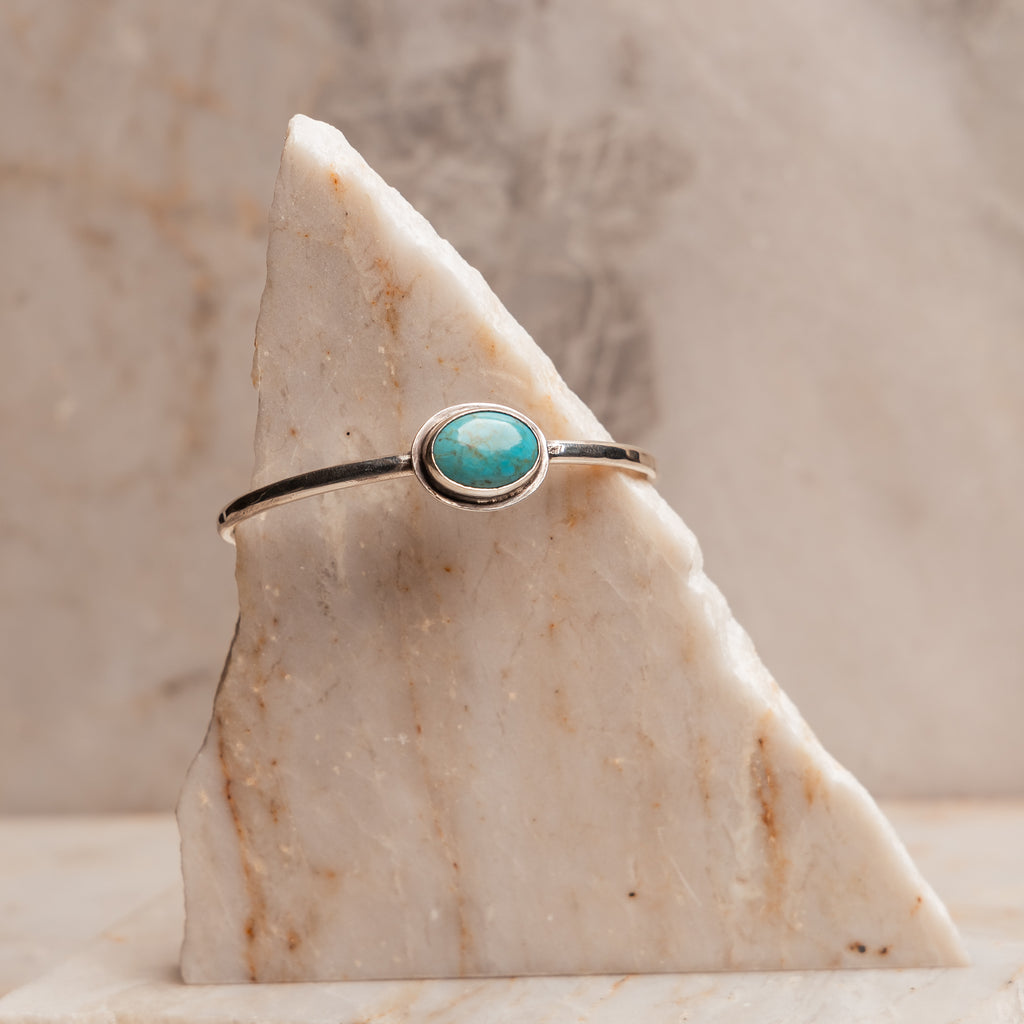 "Sterling Silver Anika Bracelet with genuine turquoise stone on minimalist cuff design."

