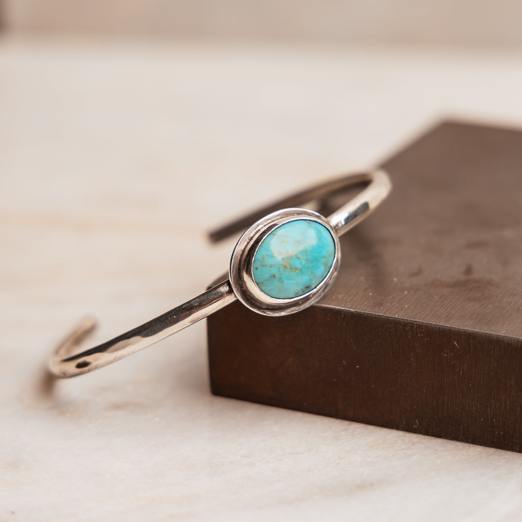 "Handcrafted Anika Sterling Silver Cuff Bracelet with authentic turquoise gemstone, adjustable fit."

