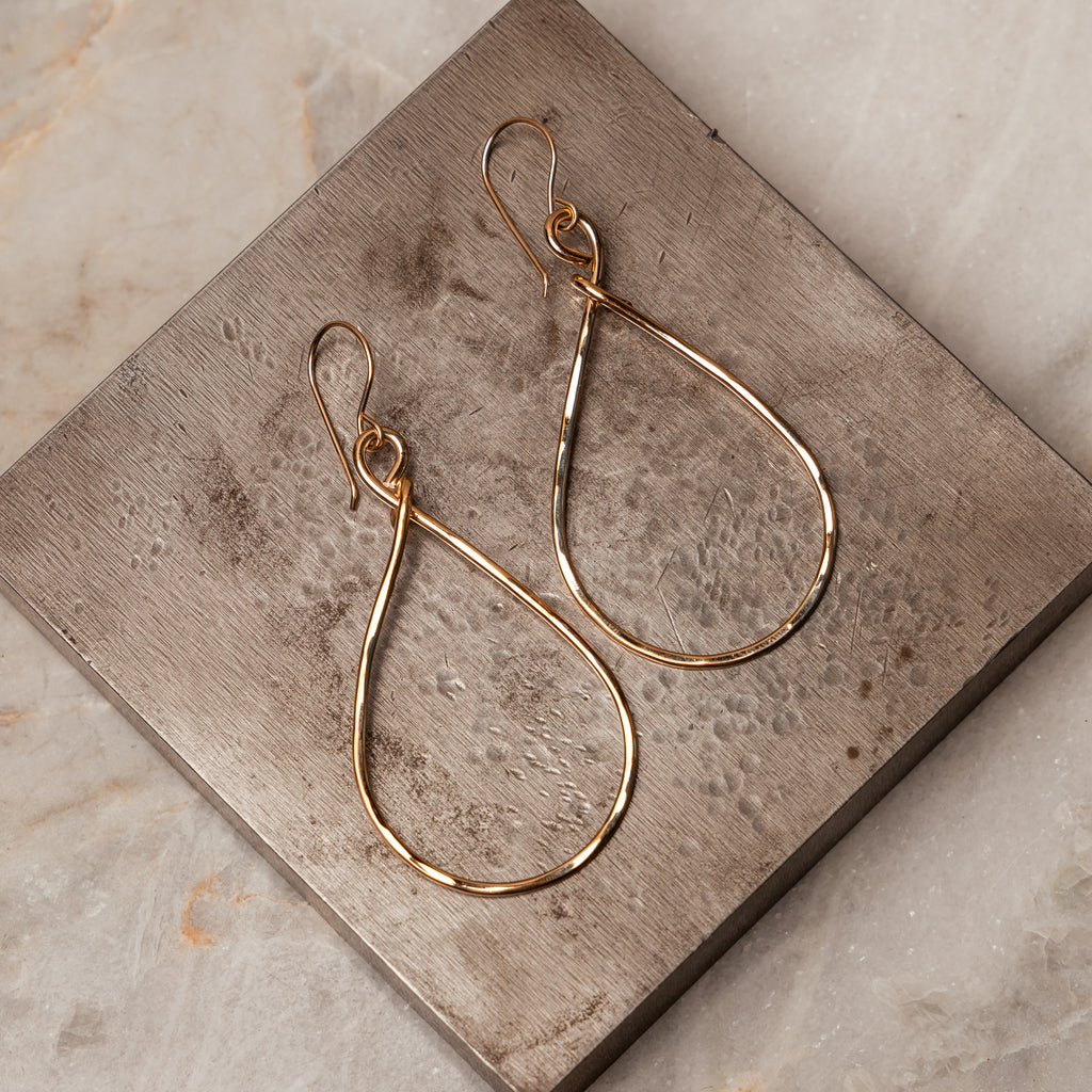 The Bailey Earrings, showcasing the hand-hammered texture and the unique teardrop design, perfect for adding a touch of sophistication.