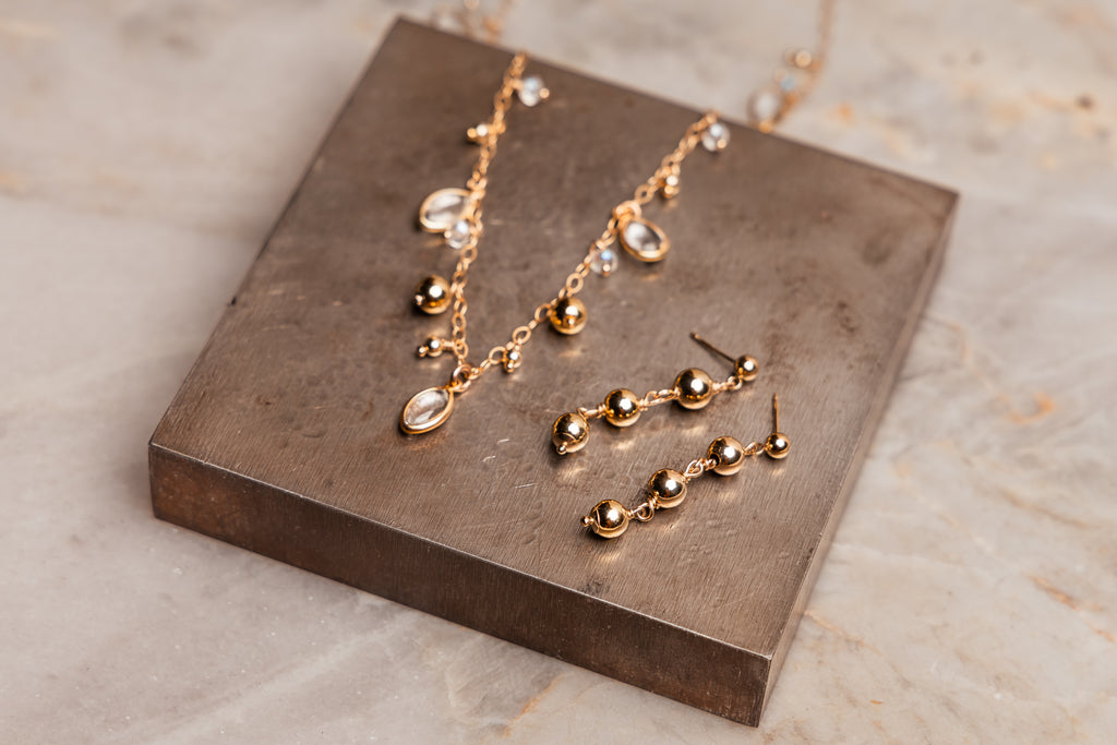 "Elegant gold filled Bijou Necklace and matching earrings set with crystal quartz details."

