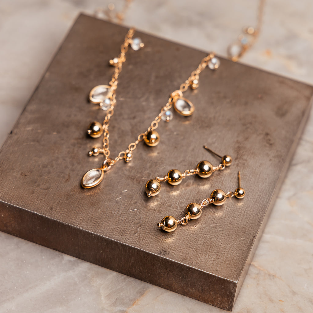 "Elegant gold filled Bijou Necklace and matching earrings set with crystal quartz details."

