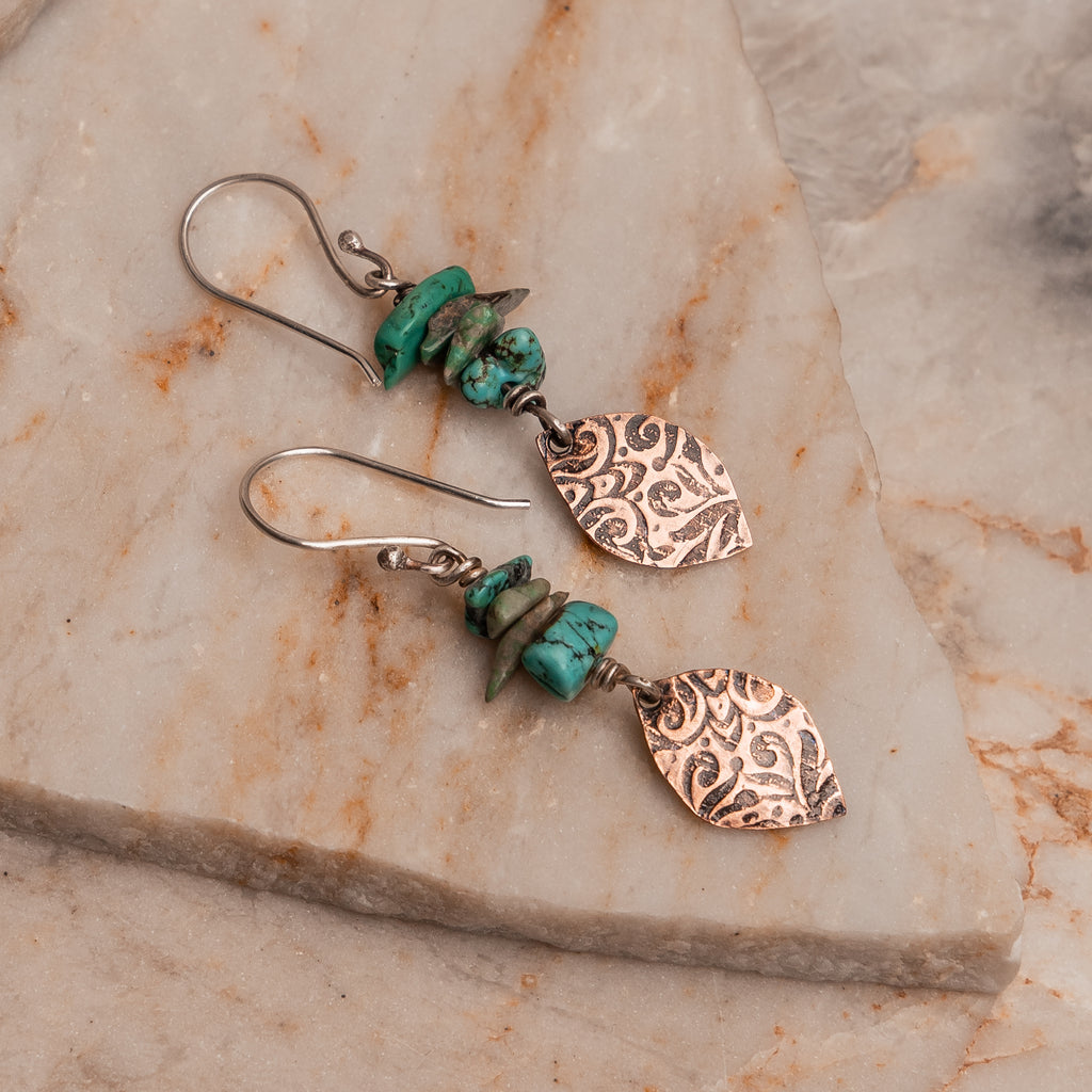 "Southwest inspired dangle earrings featuring genuine turquoise and artisan copper"