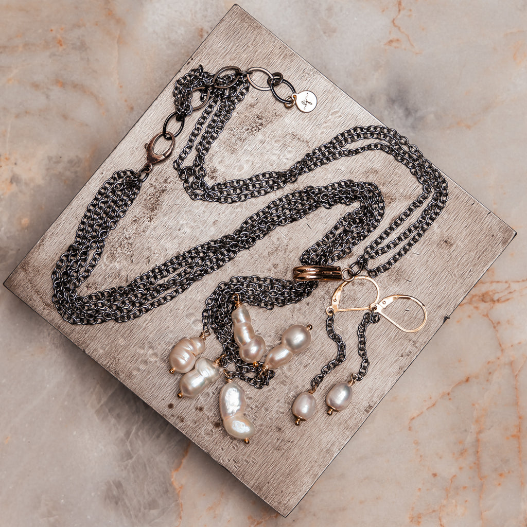 Contemporary jewelry combining gunmetal chain and freshwater pearls