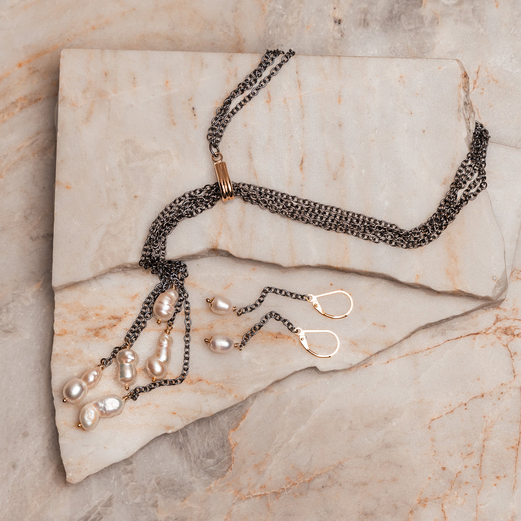 Contemporary jewelry combining gunmetal chain and freshwater pearls