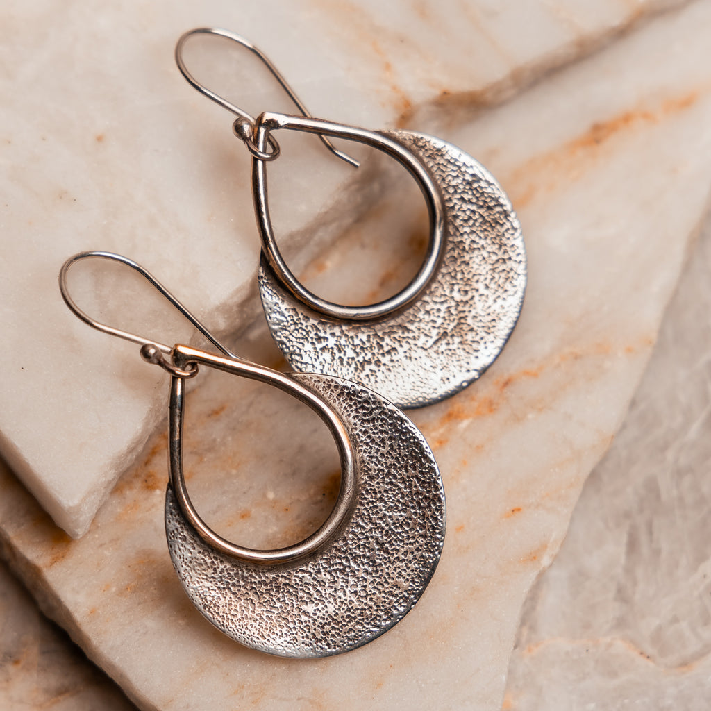 Versatile 2-inch sterling silver hoops with artisanal mountain-inspired texture