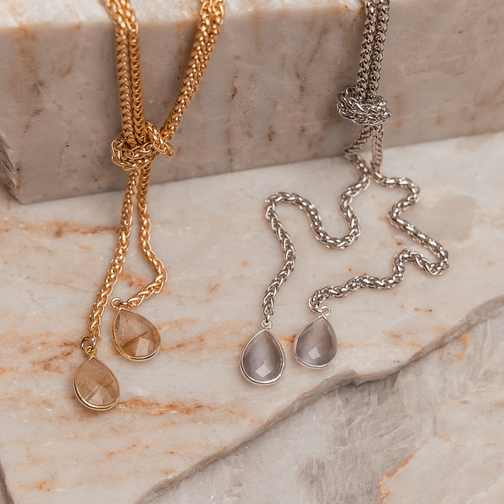 Luxury adjustable necklace featuring teardrop gemstones in gold and silver finishes