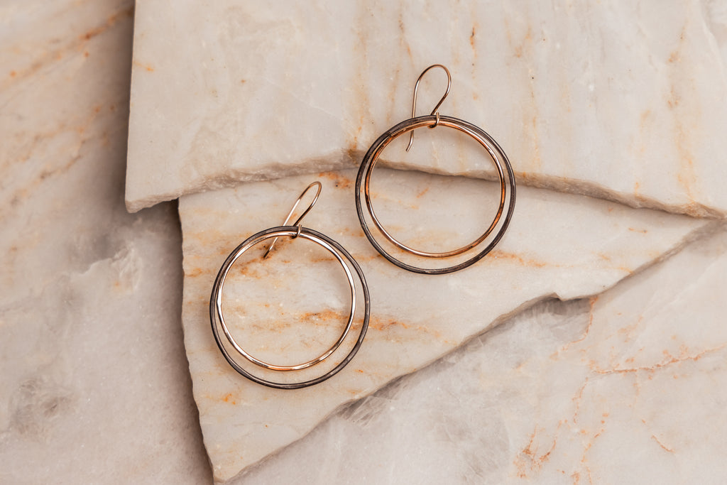 "Artisan-crafted Helena Earrings with edgy oxidized sterling silver and shiny gold-filled hoops."

