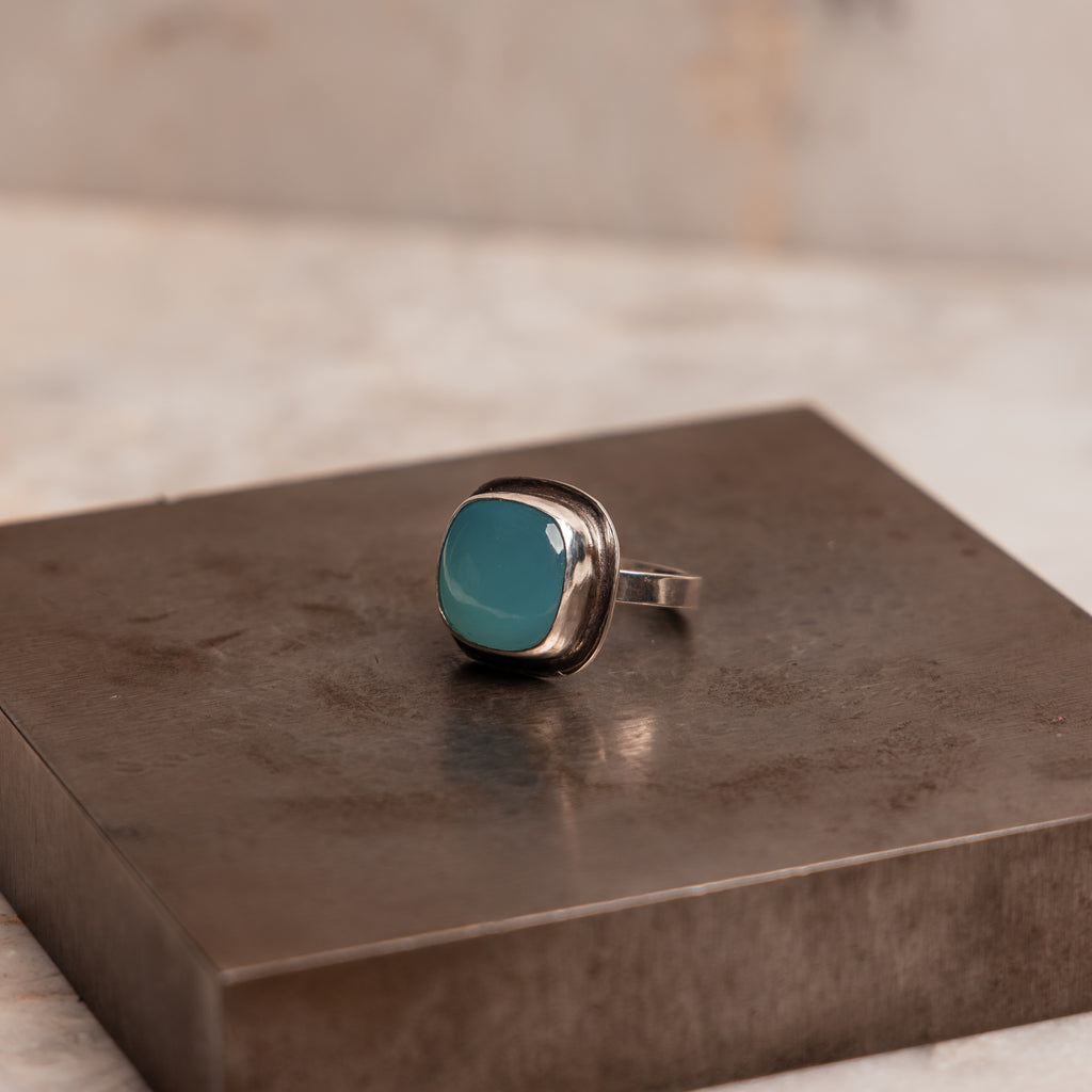 Handcrafted silver cocktail ring featuring smooth blue-green Paraiba agate cabochon in minimalist design