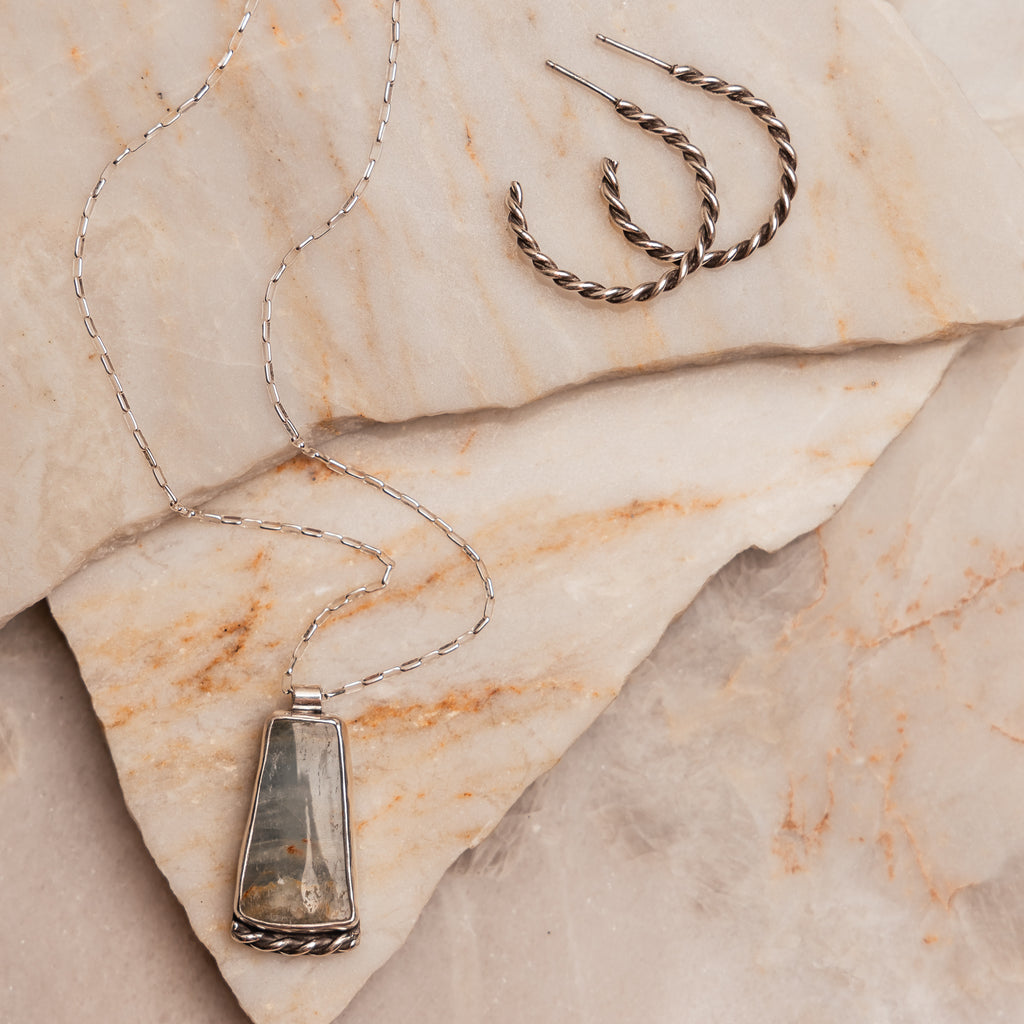 "Artisan-crafted Isa Necklace featuring a blue calcite gemstone and sterling silver setting."

