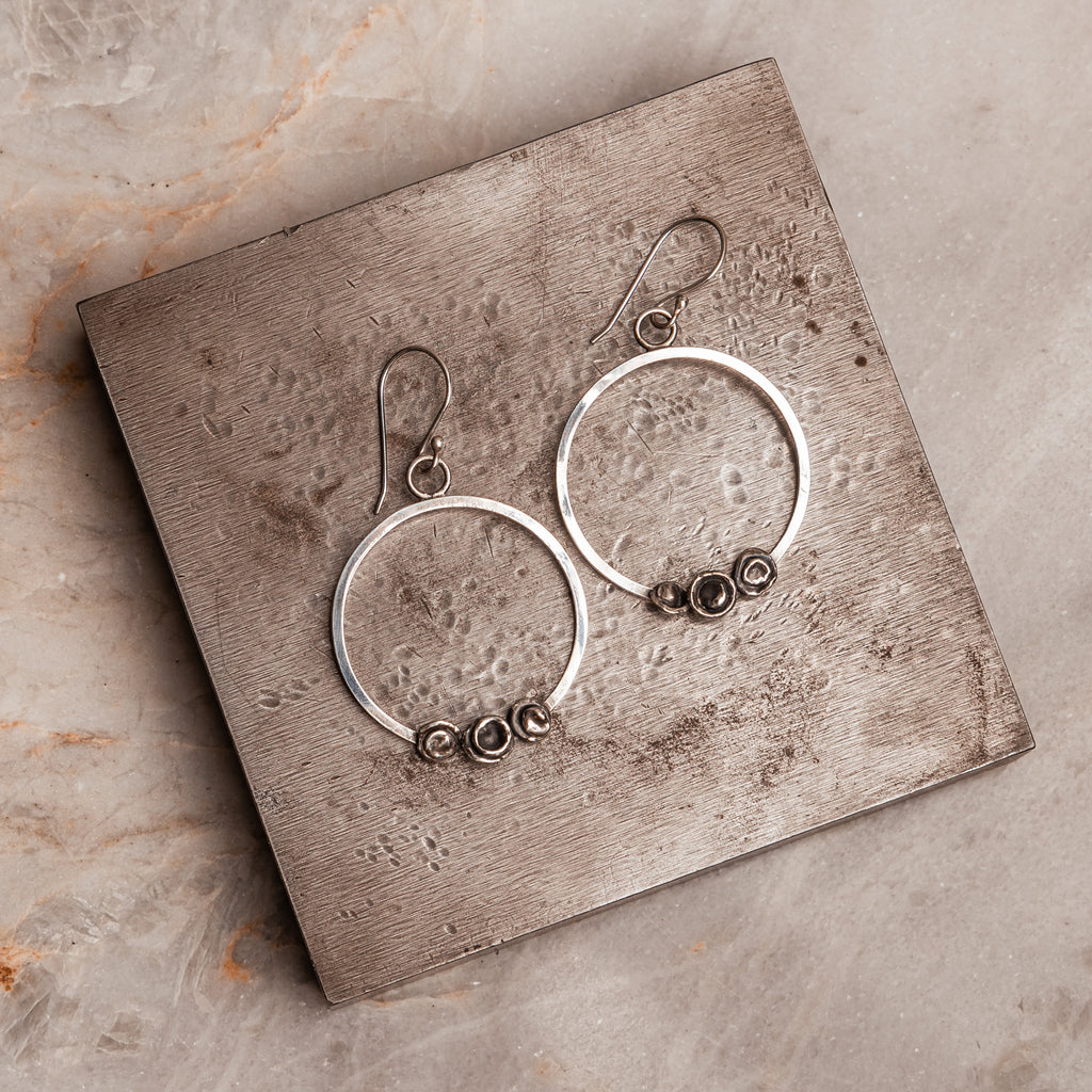 Modern Sterling silver hoop earrings with sculptural elements