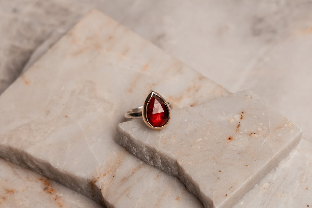 "Contemporary mixed metal jewelry - garnet ring with 14k gold bezel and sterling silver band"