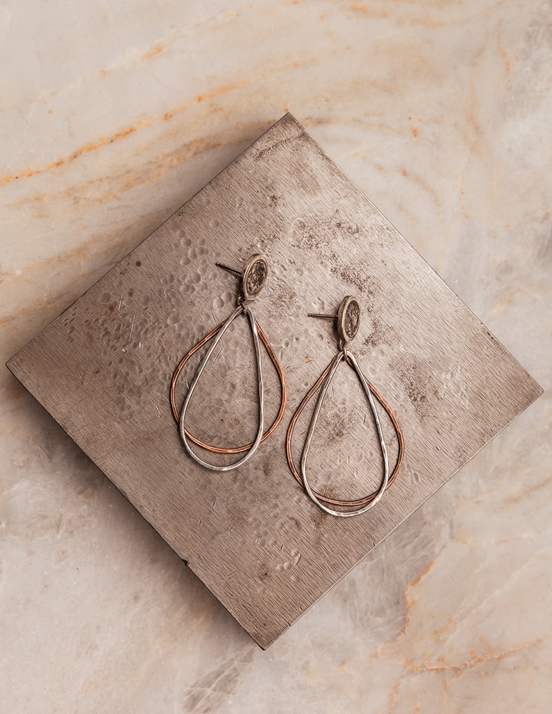 "Luxe bohemian Roxanna Earrings with sterling silver and copper elements in flowing teardrop shape."

