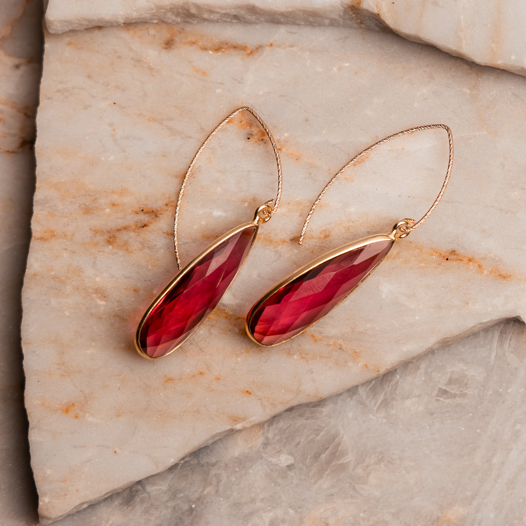 Contemporary gold earring design featuring rubelite quartz