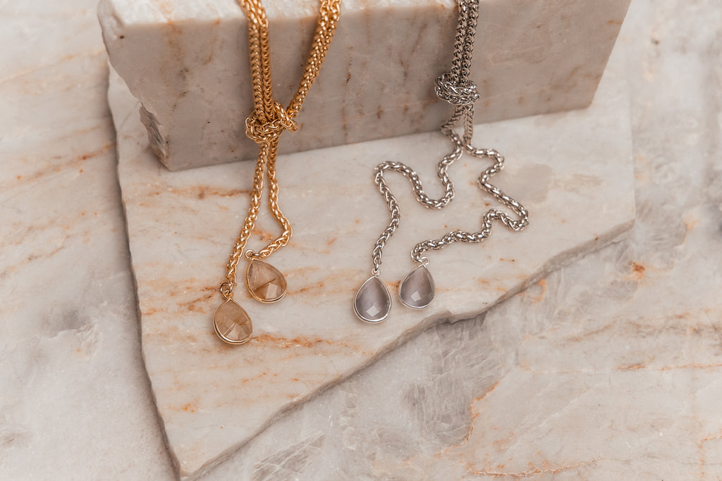 Luxury adjustable necklace featuring teardrop gemstones in gold and silver finishes - Genevieve collection