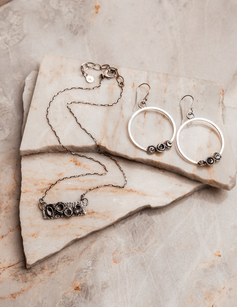 "Designer Parker Hoop Earrings and matching necklace in sterling silver with sculptural elements and natural texture."

